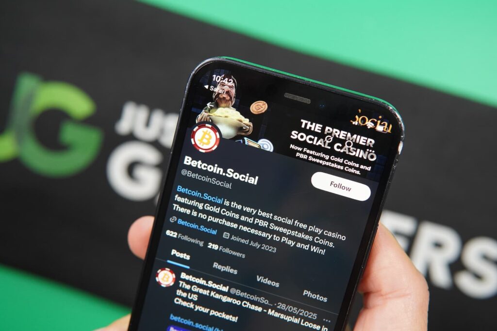 Patrik Lidin holding an iPhone with the BetcoinSocial casino social media X page loaded on the webpage.