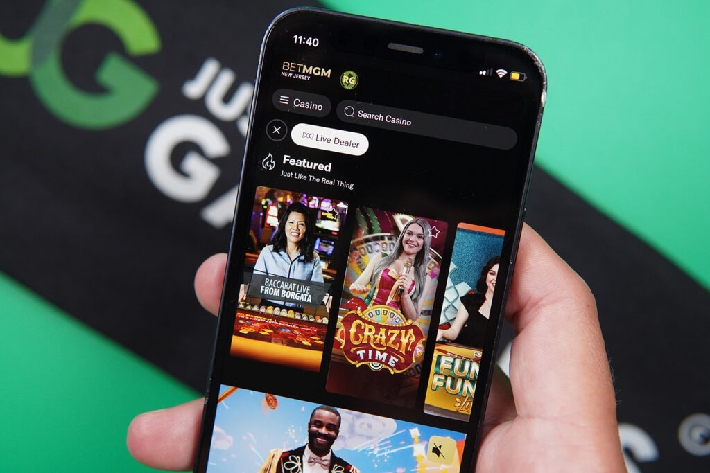 Photo of Patrik Lidin holding an iPhone with online live casino BetMGM showing.