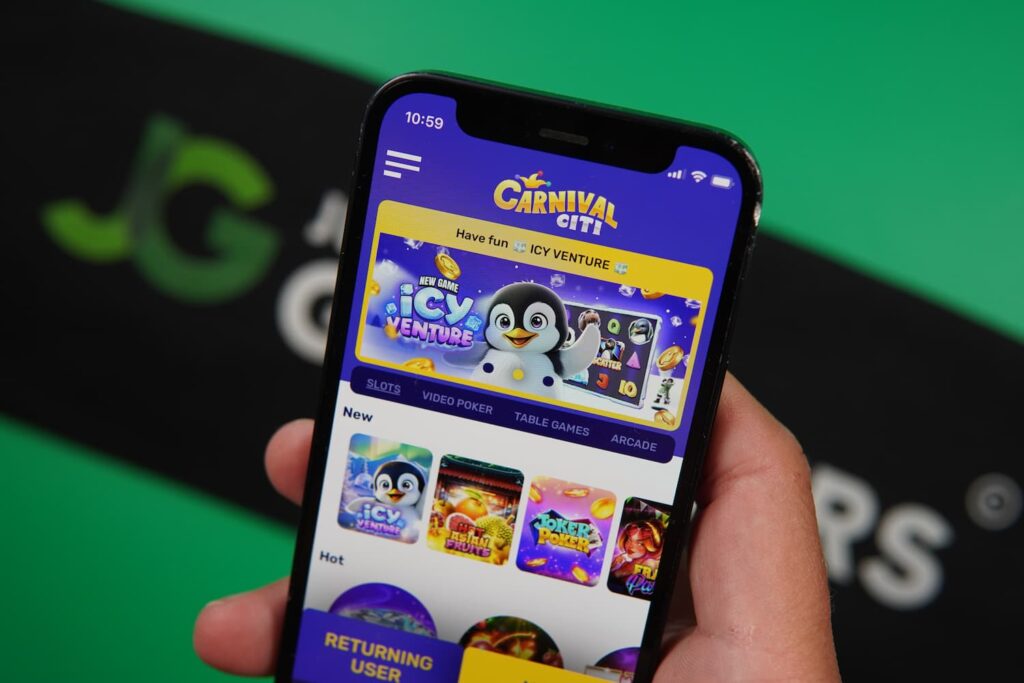 Patrik Lidin holding an iPhone with the Carnival Citi casino landing page loaded on the webpage.
