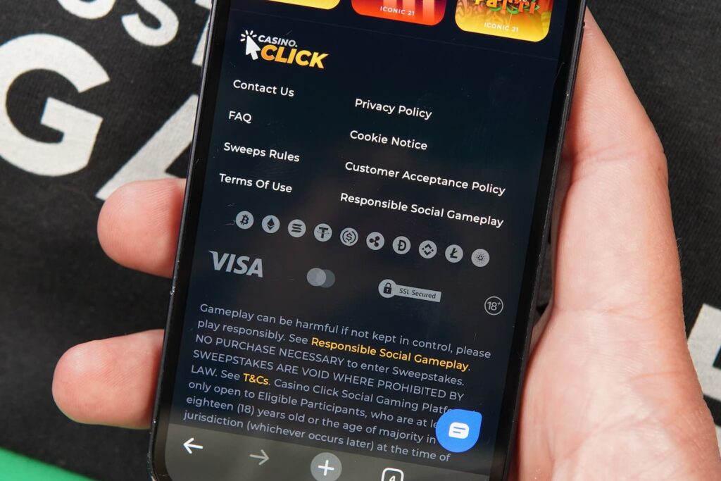 Patrik Lidin holding an iPhone with the Casino Click casino payments page loaded on the webpage.