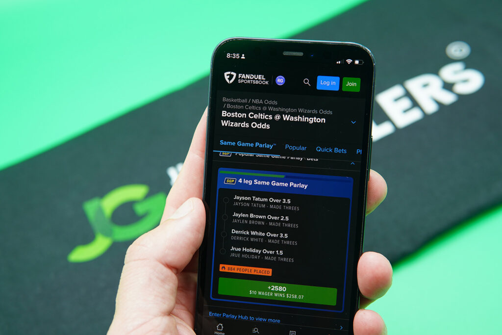Photo of Patrik Lidin holding an iPhone with FanDuel sportsbook showing on the screen.