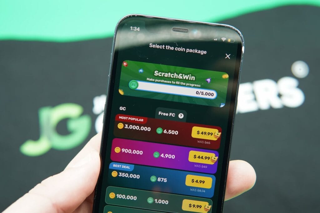 Patrik Lidin holding an iPhone with the Fortune Wheelz casino purchases page loaded on the webpage.