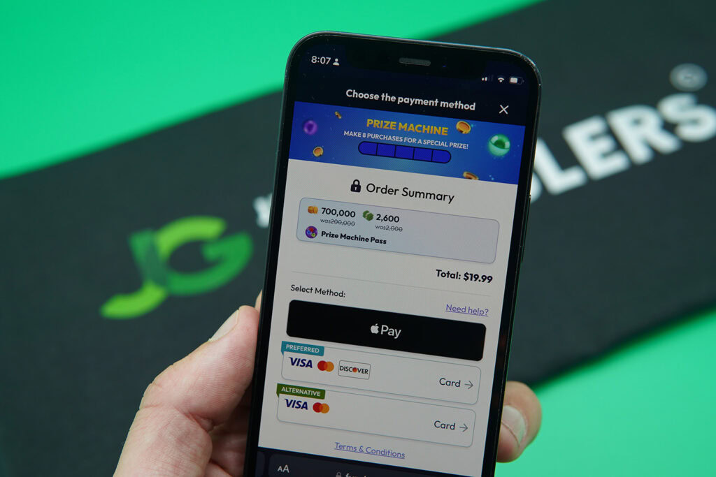 Patrik Lidin holding an iPhone when purchasing coins on Funrize casino.