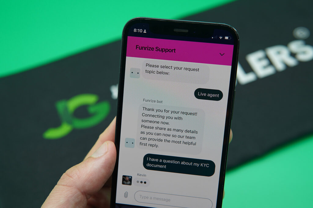 Patrik Lidin holding an iPhone while using the Funrize customer support.