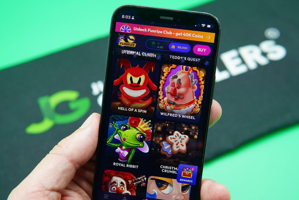 Patrik Lidin holding an iPhone with Funrize game library showing.