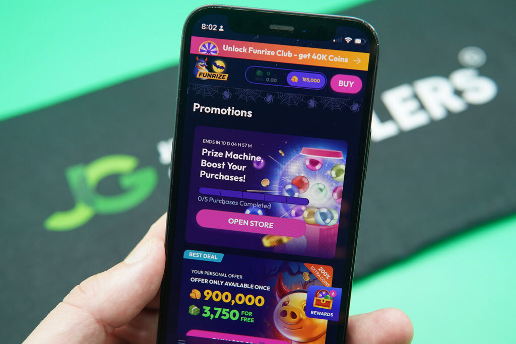 Patrik Lidin holding an iPhone with the Funrize rewards page loaded on the webpage.