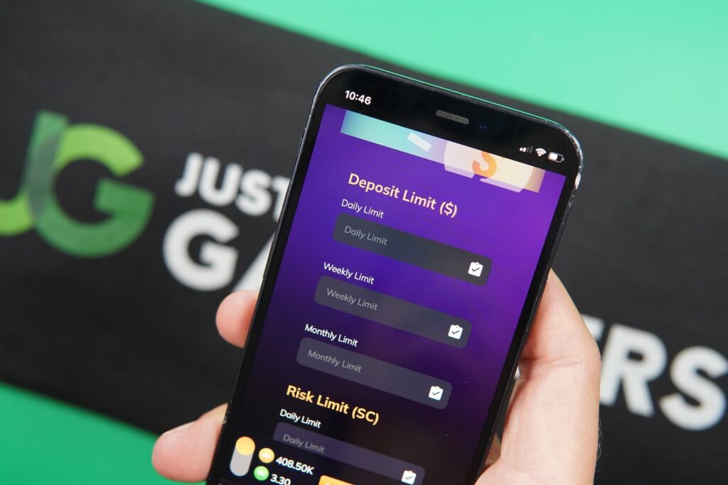 Patrik Lidin holding an iPhone with the GoldNLuck casino Responsible Gaming page loaded on the webpage.
