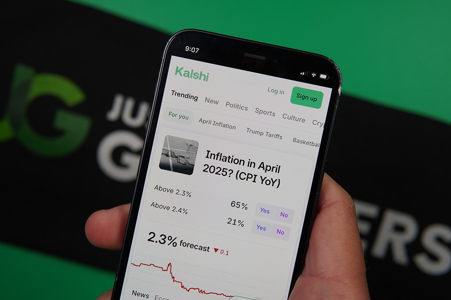 Photo of Patrik Lidin holding an iPhone with Kalshi landing page loaded.