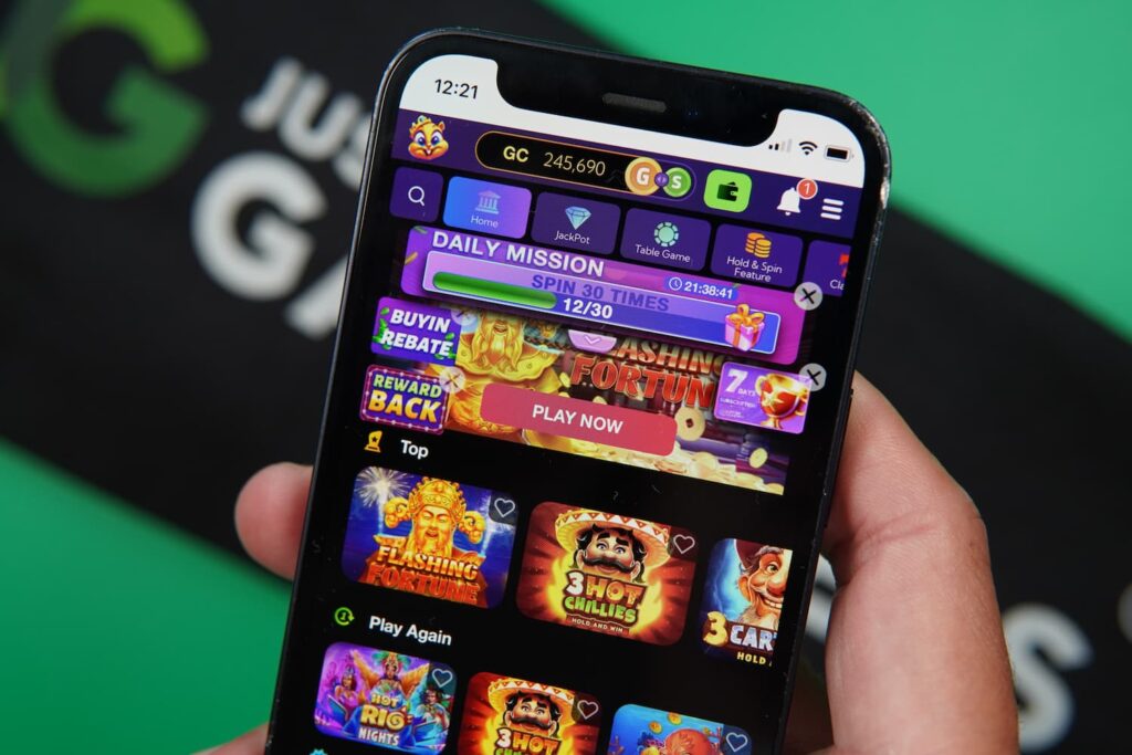Patrik Lidin holding an iPhone with the Lavish Luck casino landing page loaded on the webpage.