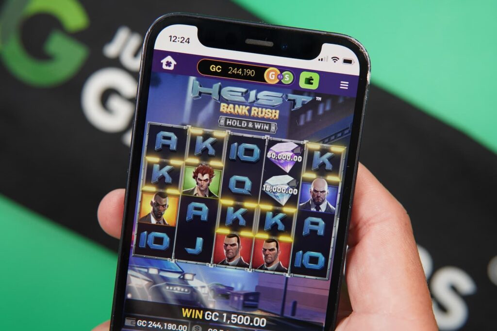 Patrik Lidin holding an iPhone with the Lavish Luck casino mobile game page loaded on the webpage.