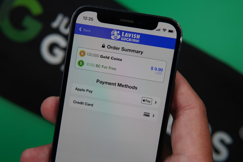 Patrik Lidin holding an iPhone with the Lavish Luck casino payments page loaded on the webpage.