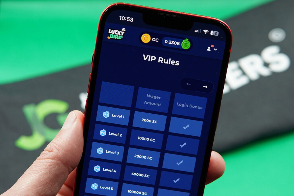 Patrik Lidin holding an iPhone showing the LuckyBird.io VIP program on the webpage.