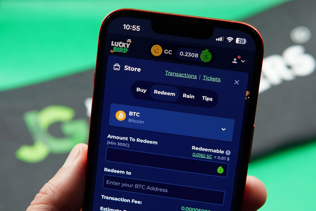 Patrik Lidin holding an iPhone with the LuckyBird.io redemptions loaded on the webpage.