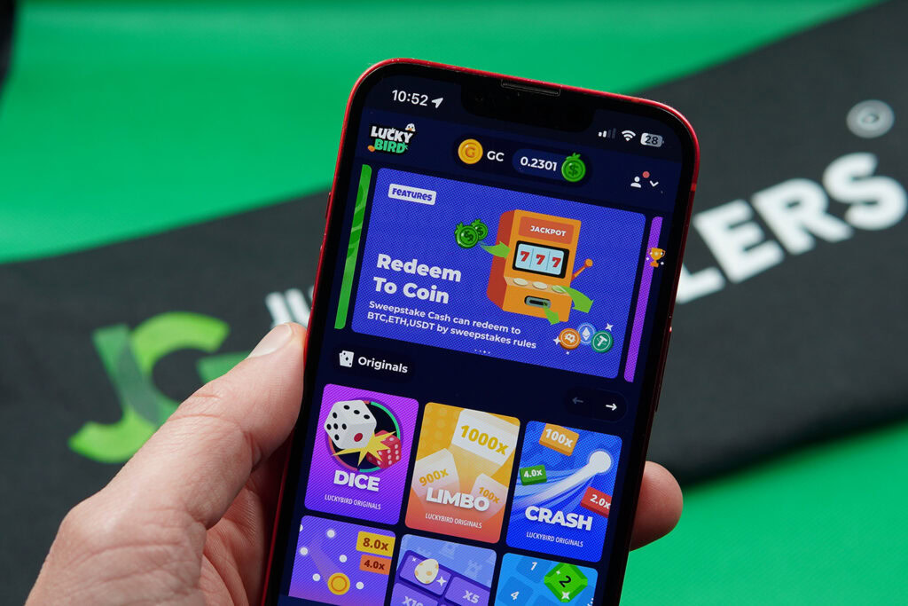 Photo of Patrik Lidin holding an iPhone to show how the Luckybird.io Casino looks.