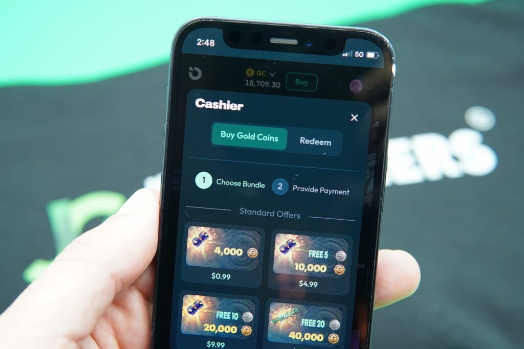 Patrik Lidin holding an iPhone with the Moonspin coin purchases page loaded on the webpage.