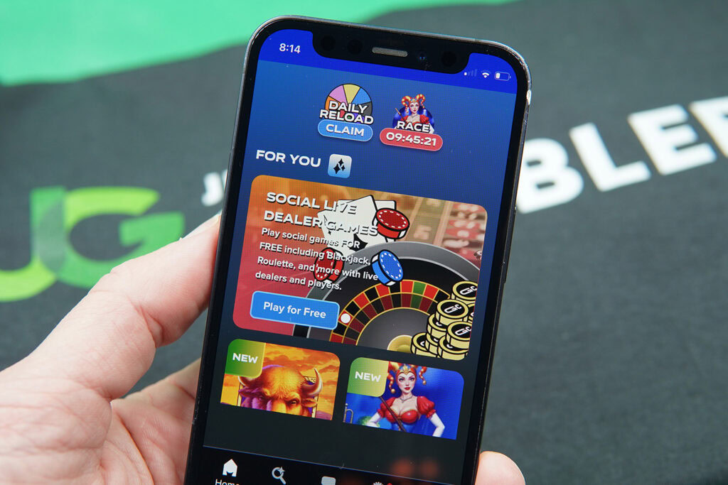 Photo of Patrik Lidin holding an iPhone to show how the MyPrize Casino looks.