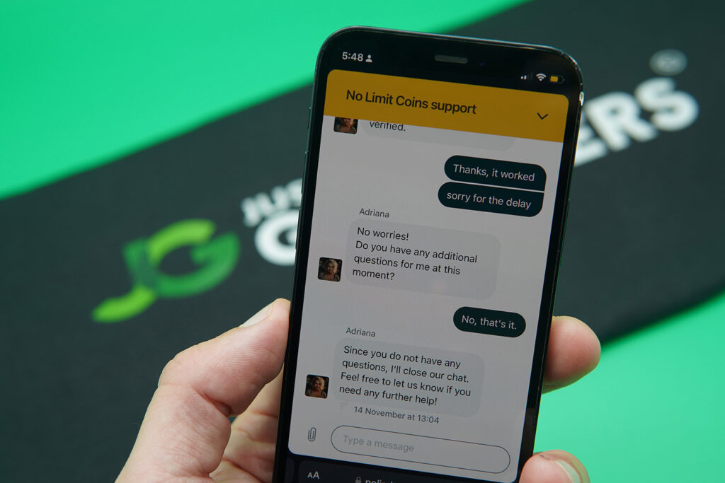 Patrik Lidin holding an iPhone while using the NoLimitCoins customer support.