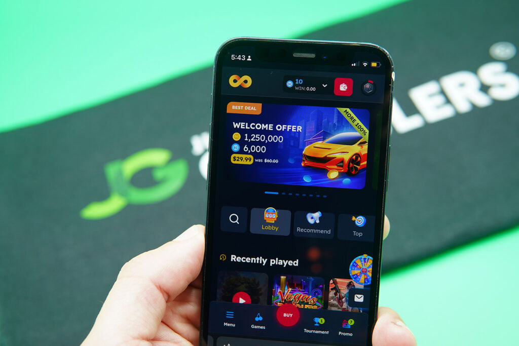 Photo of Patrik Lidin holding an iPhone to show how the NoLimitCoins Casino looks.