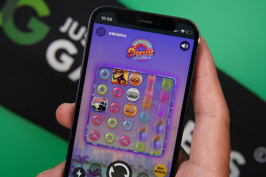 Photo of Patrik Lidin holding an iPhone showing a game that is not a live casino game.