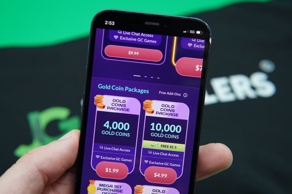 Patrik Lidin holding an iPhone with the PlayFame coin purchases page loaded on the webpage.