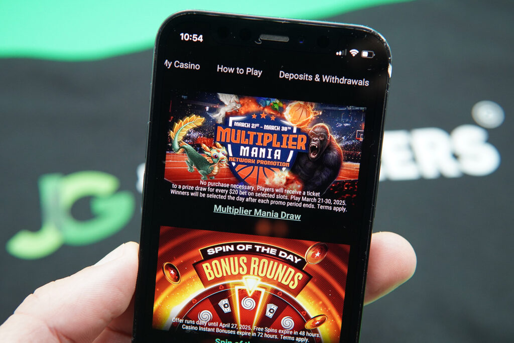 Photo of Patrik Lidin holding iPhone with PokerStars NJ welcome bonus loaded.