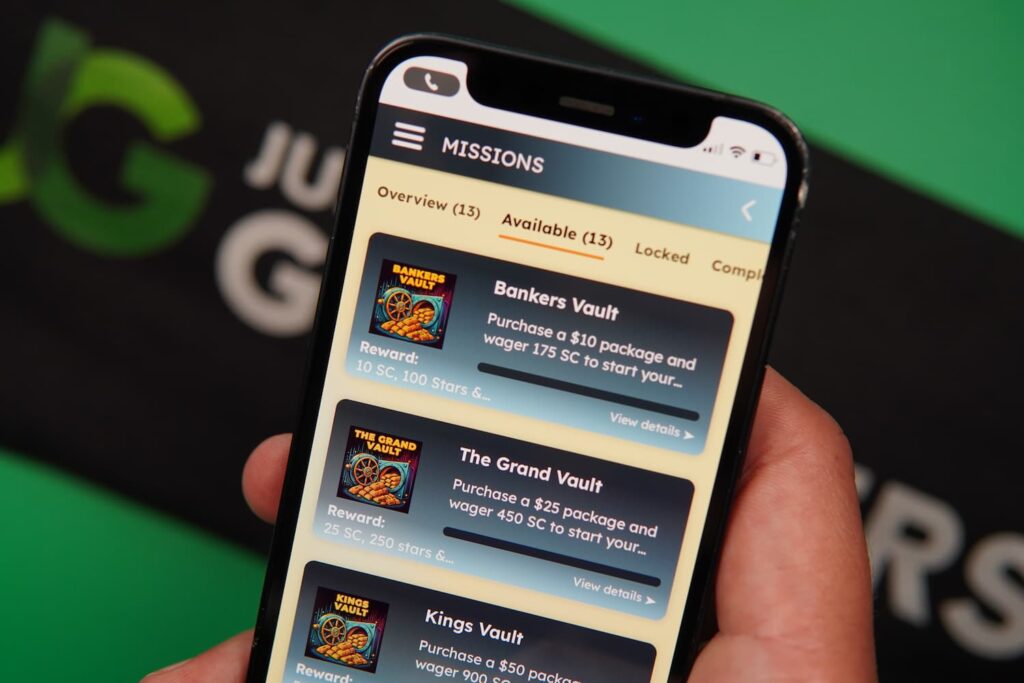 Patrik Lidin holding an iPhone with the Spinfinite casino missions page loaded on the webpage.