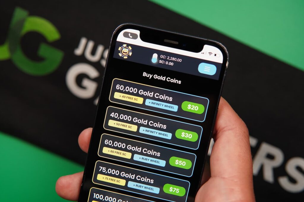 Patrik Lidin holding an iPhone with the Spinfinite casino purchases page loaded on the webpage.