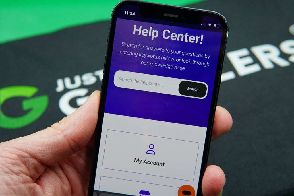Patrik Lidin holding an iPhone while using the SweepSlots customer support.