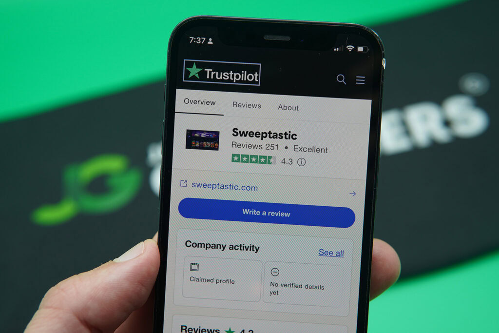 Patrik Lidin holding an iPhone showing Sweeptastic Trustpilot rating.